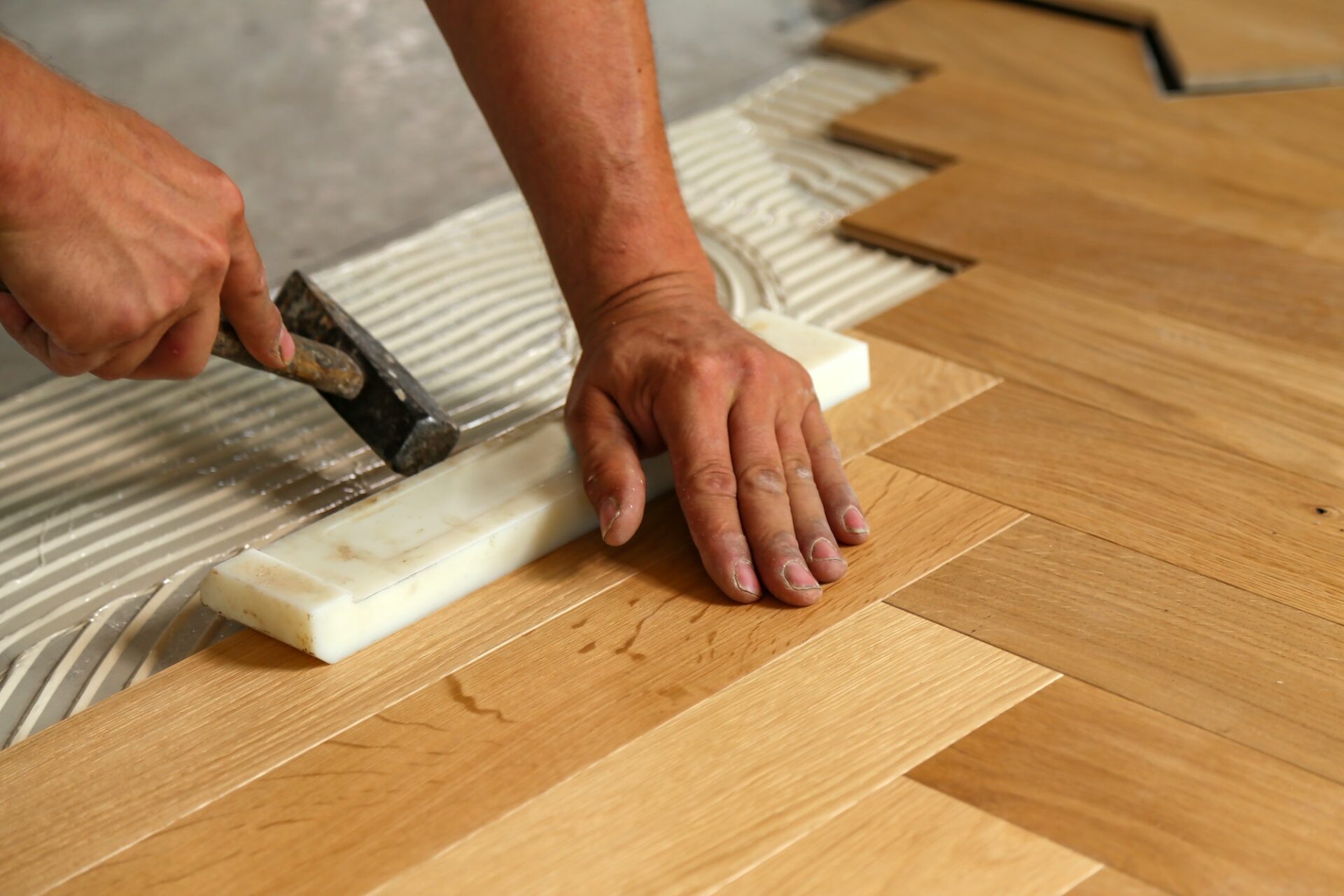 Worker installing parquet flooring